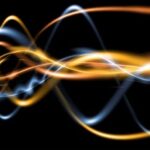 Abstract gold and blue energy waves representing SCENAR electrical signals.