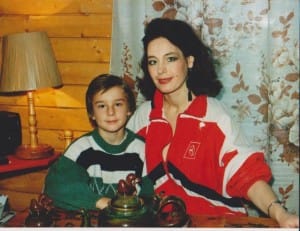Irena and Denis sitting together in a wood-paneled room, 1993.