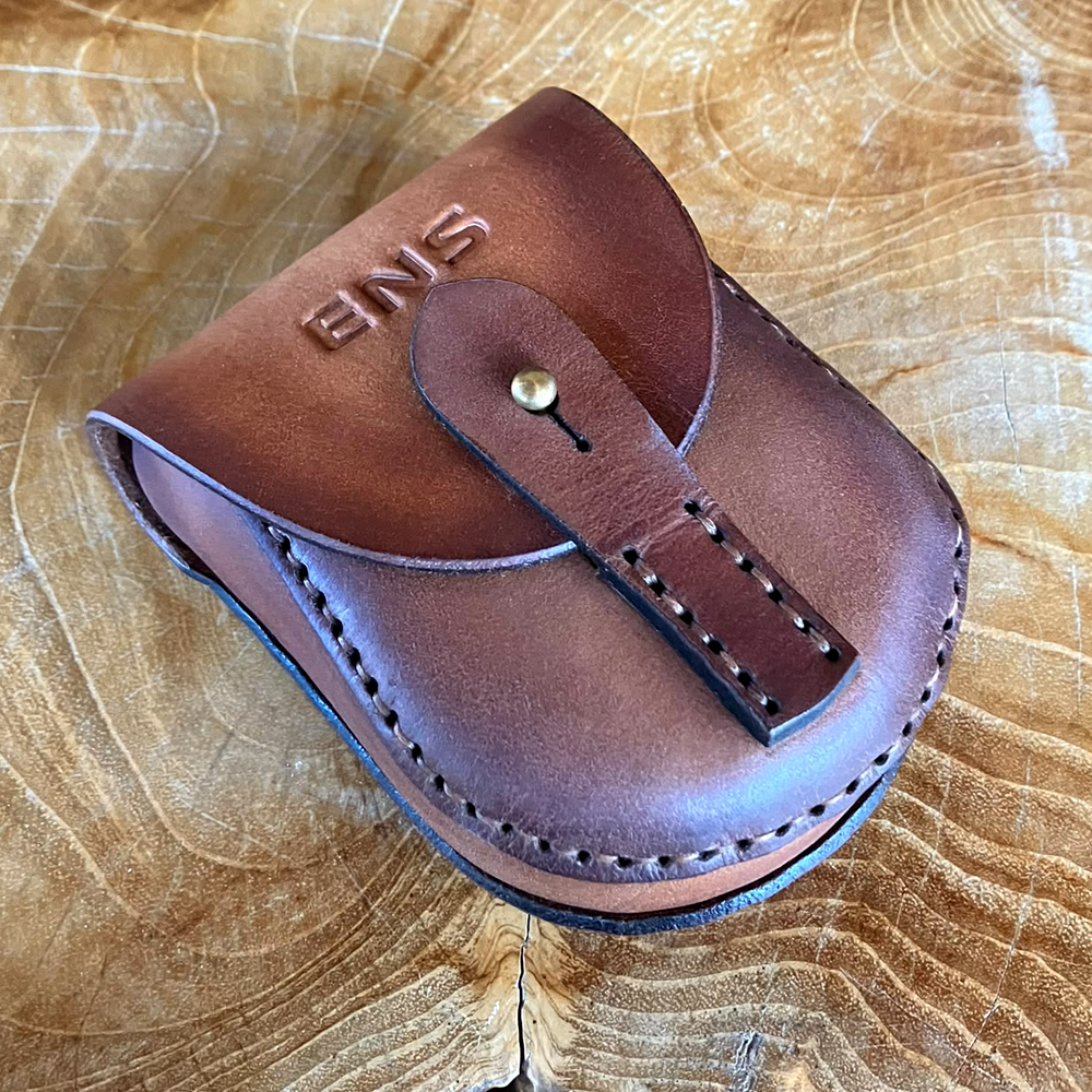 Brown leather carrying case embossed with ENS for the ENS Actu remote electrode.